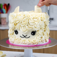 image of ears being added onto an easy llama birthday cake