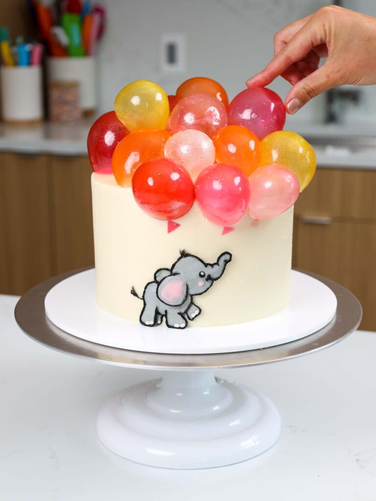 image of gelatin bubbles being added to the top of a cake