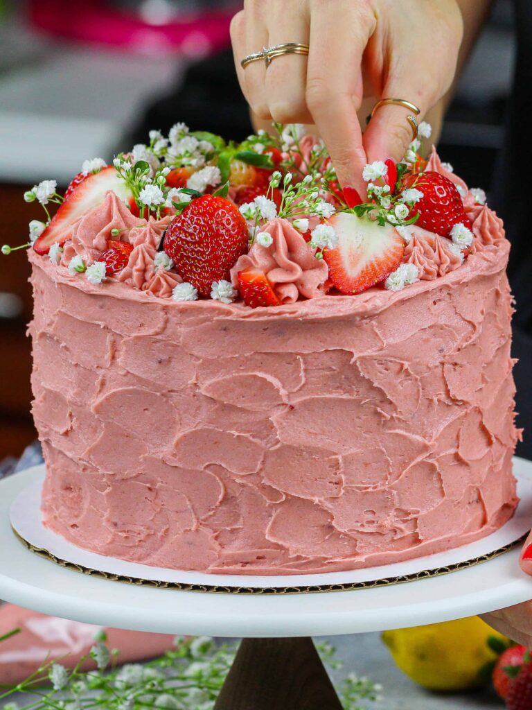 image of vanilla strawberry cake with vanilla cake layers and strawberry buttercream