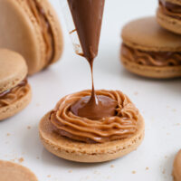 image of a nutella macaron being filled with a straight up nutella center