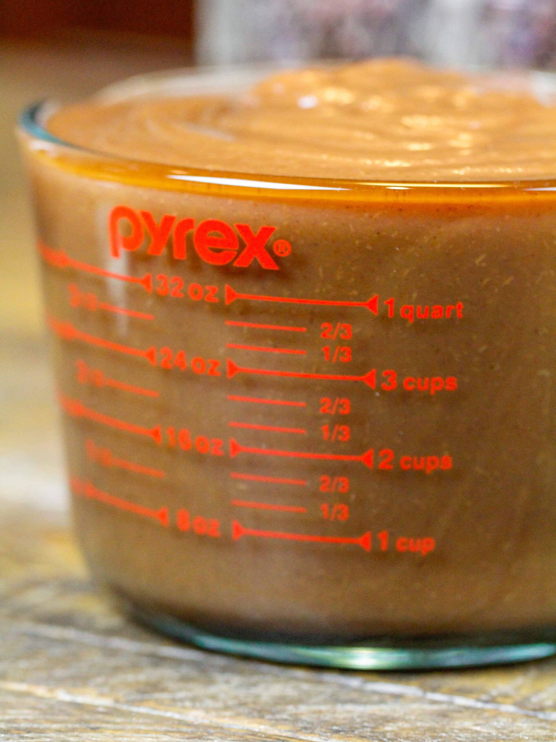 image of one batch of apple butter in a pyrex measuring cup showing that one batch makes about 5 cups