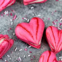 image of pink heart shaped macarons filled with buttercream