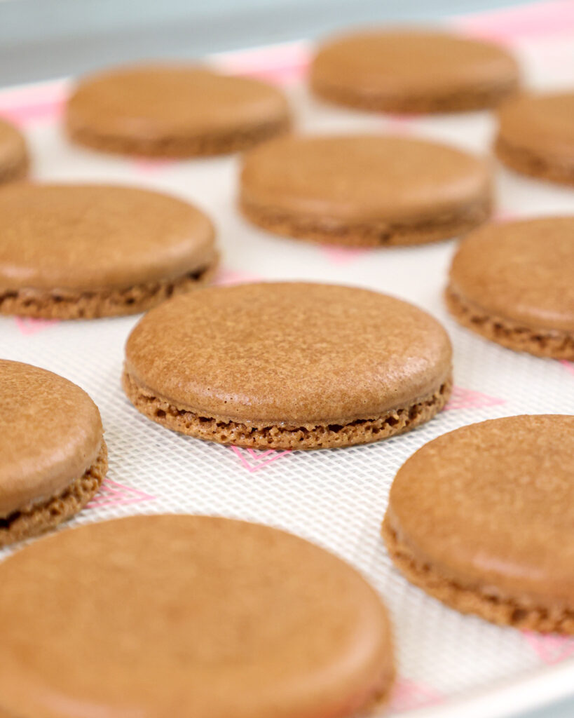 image of chocolate macaron shells that have been baked