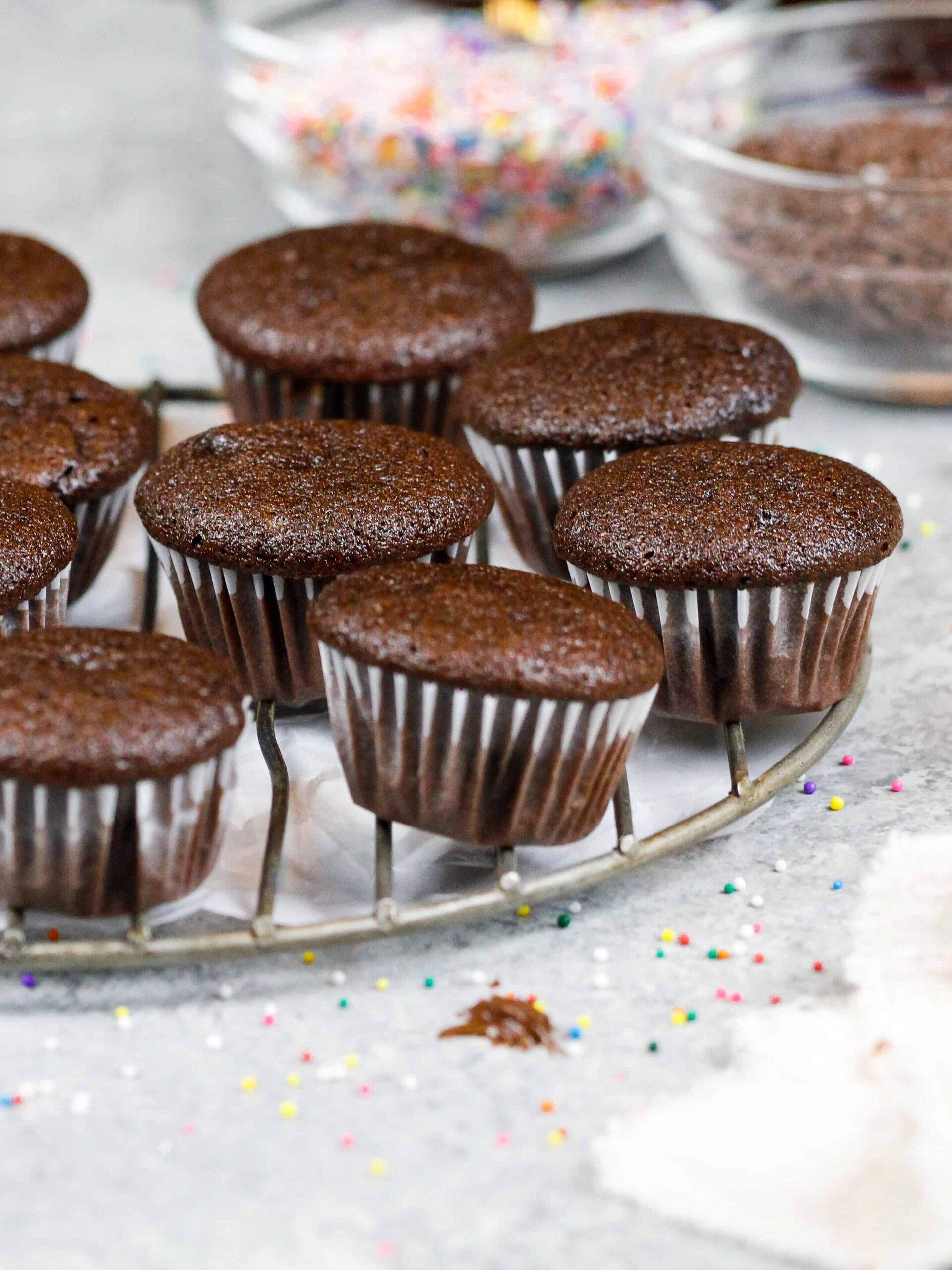 image of mini chocolate cupcakes baked and cooling on a wire rack