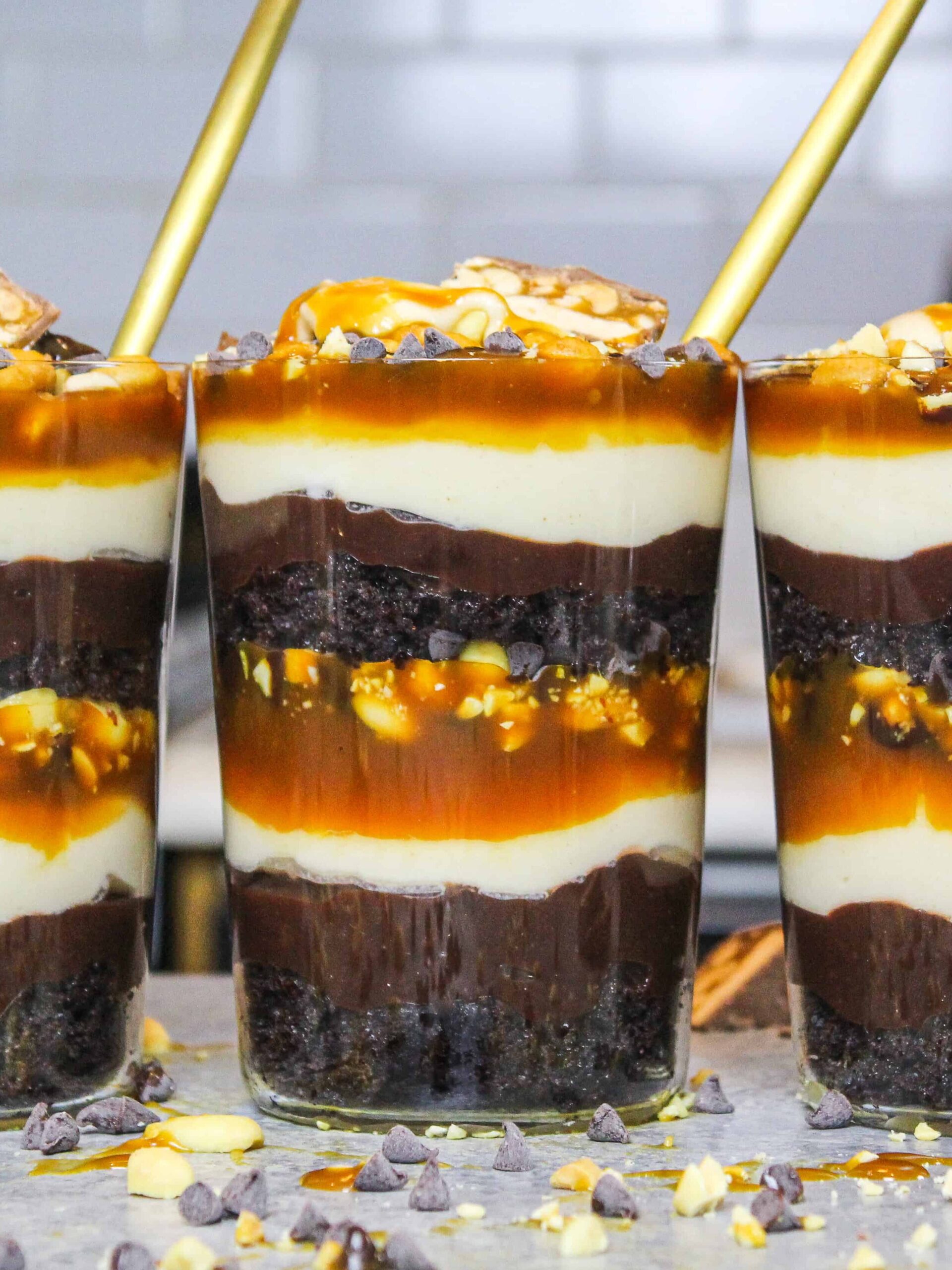 image of snickers trifles made in individual glasses to make them easy to serve and eat