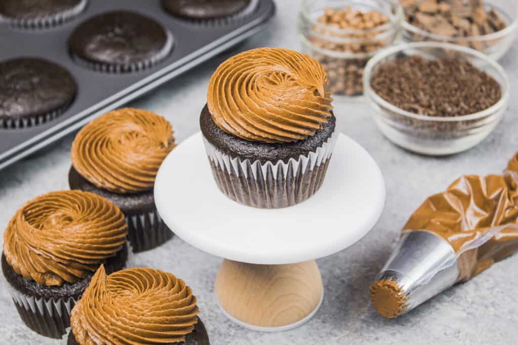 image of gluten free chocolate cupcakes frosted with a swirl of dark chocolate frosting