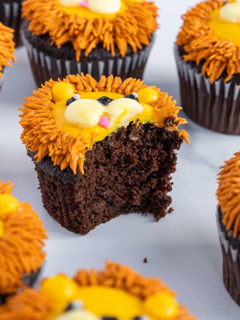 image of a lion cupcake that's been bitten into to show how moist and tender they are