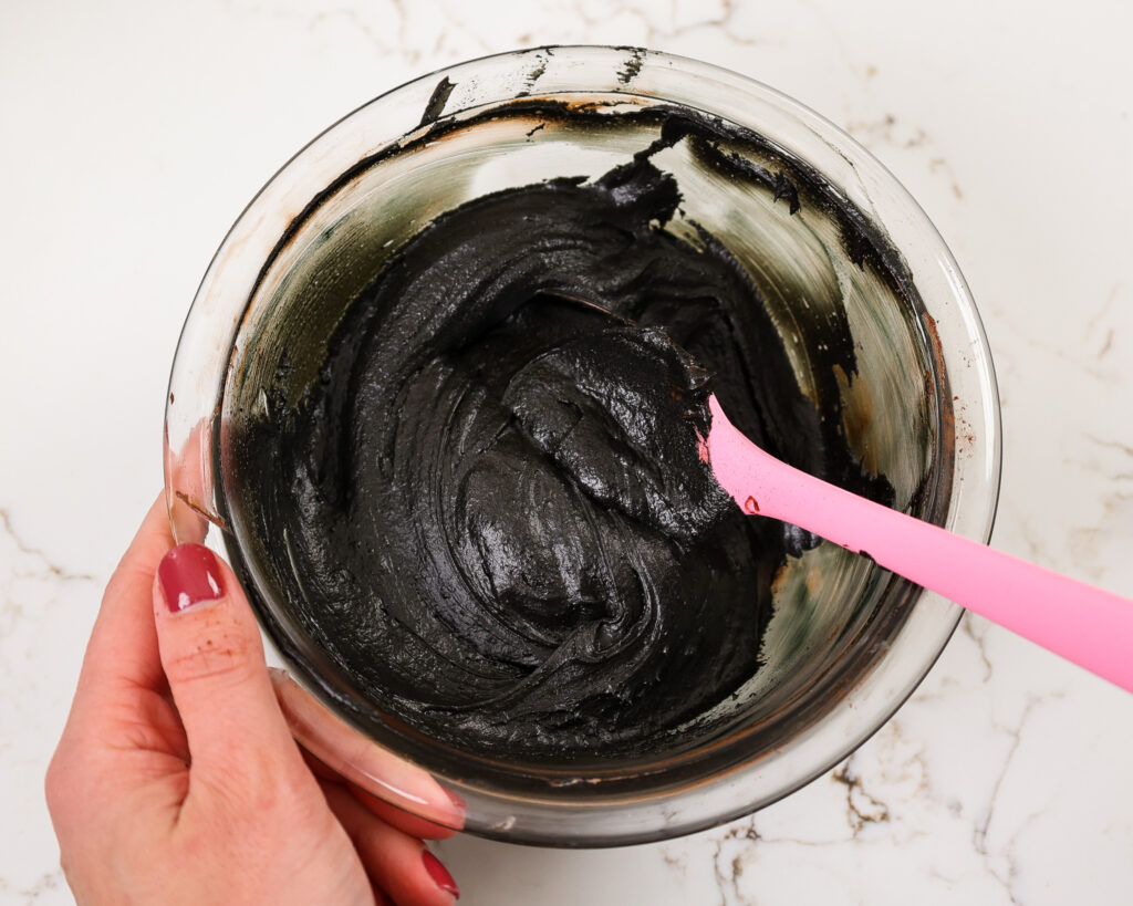 image of dark black buttercream in a bowl