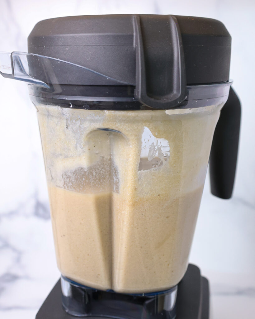 image of a dirty monkey frozen rum cocktail being blended together in a blender
