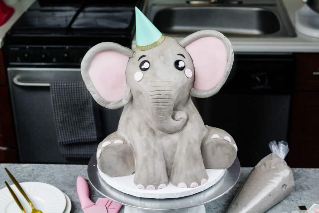 image of an elephant cake made mostly with buttercream and a little pink fondant