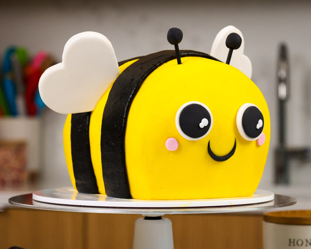 image of an adorable bumblebee cake made with black cocoa and honey buttercream