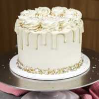 image of a white drip cake made with white chocolate ganache drips