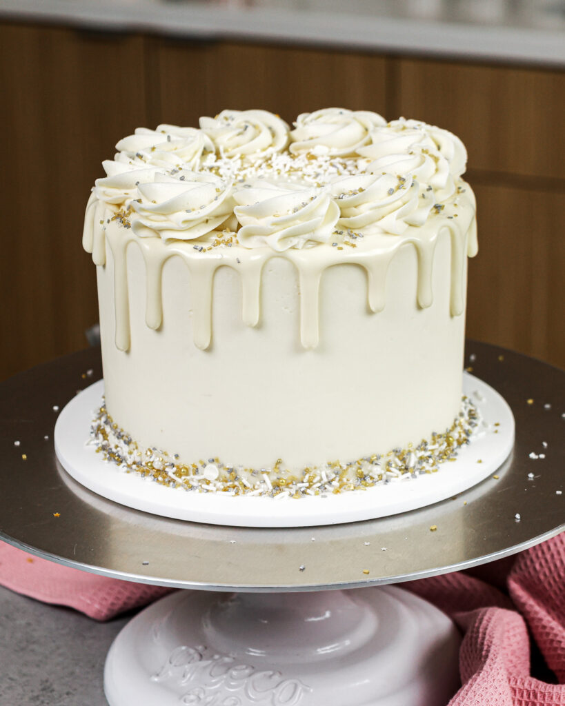 image of a white drip cake made with white chocolate ganache drips