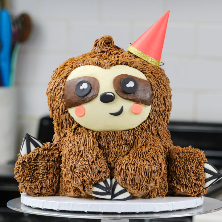 image of a sloth birthday cake made with chocolate cake layers and chocolate peanut butter buttercream