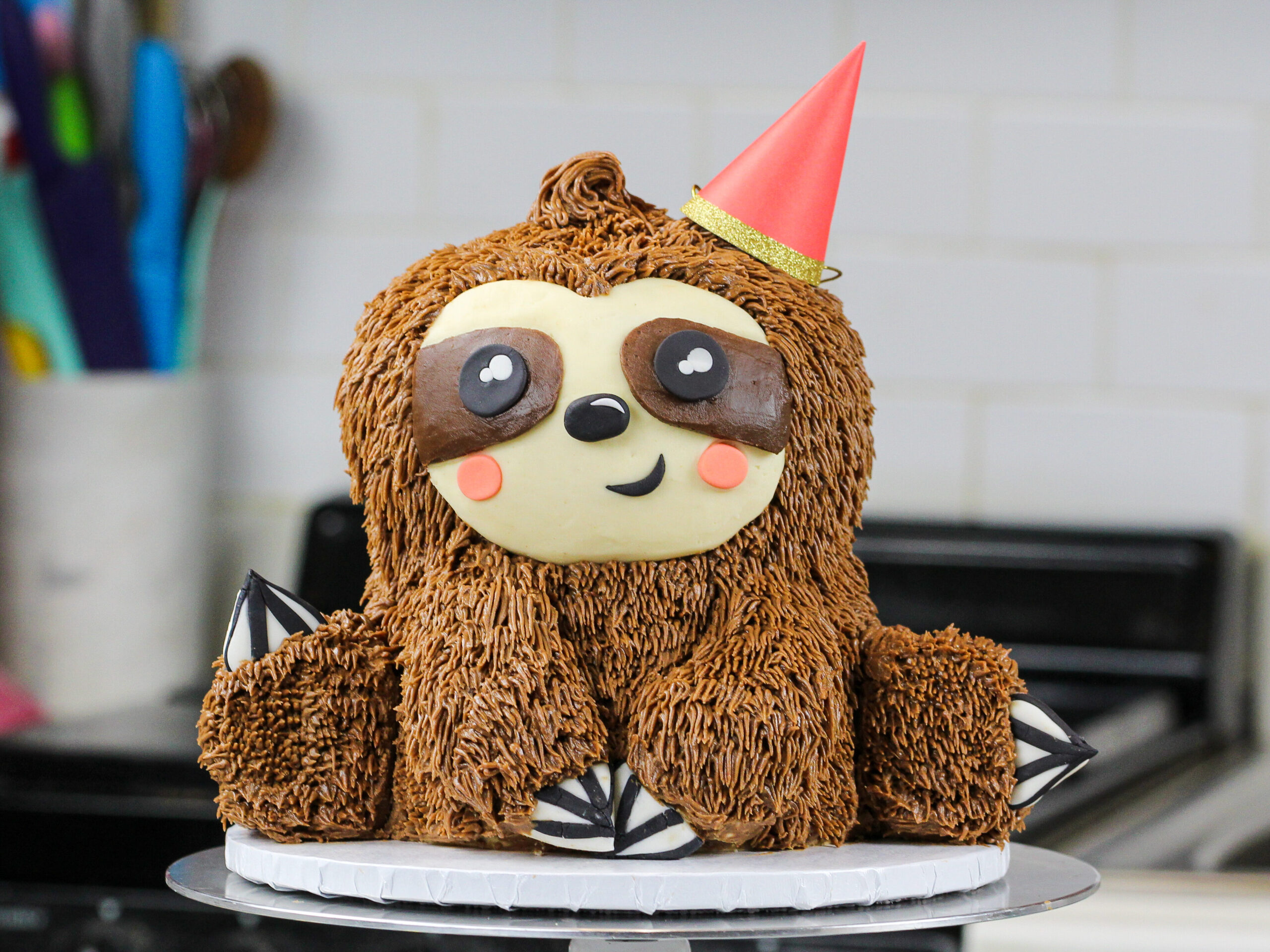 image of a sloth birthday cake made with chocolate cake layers and chocolate peanut butter buttercream