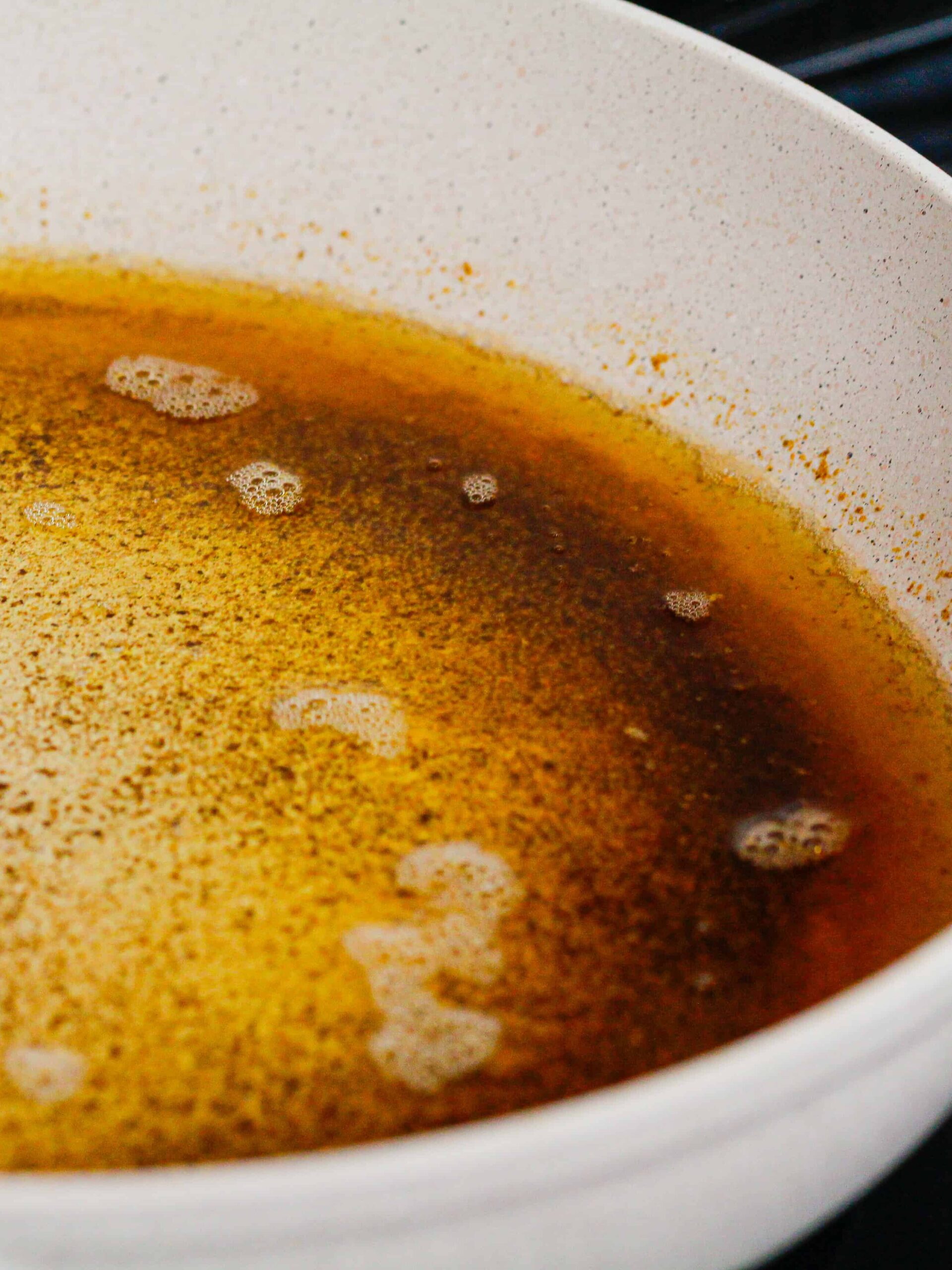 image of butter being browned in a white pan