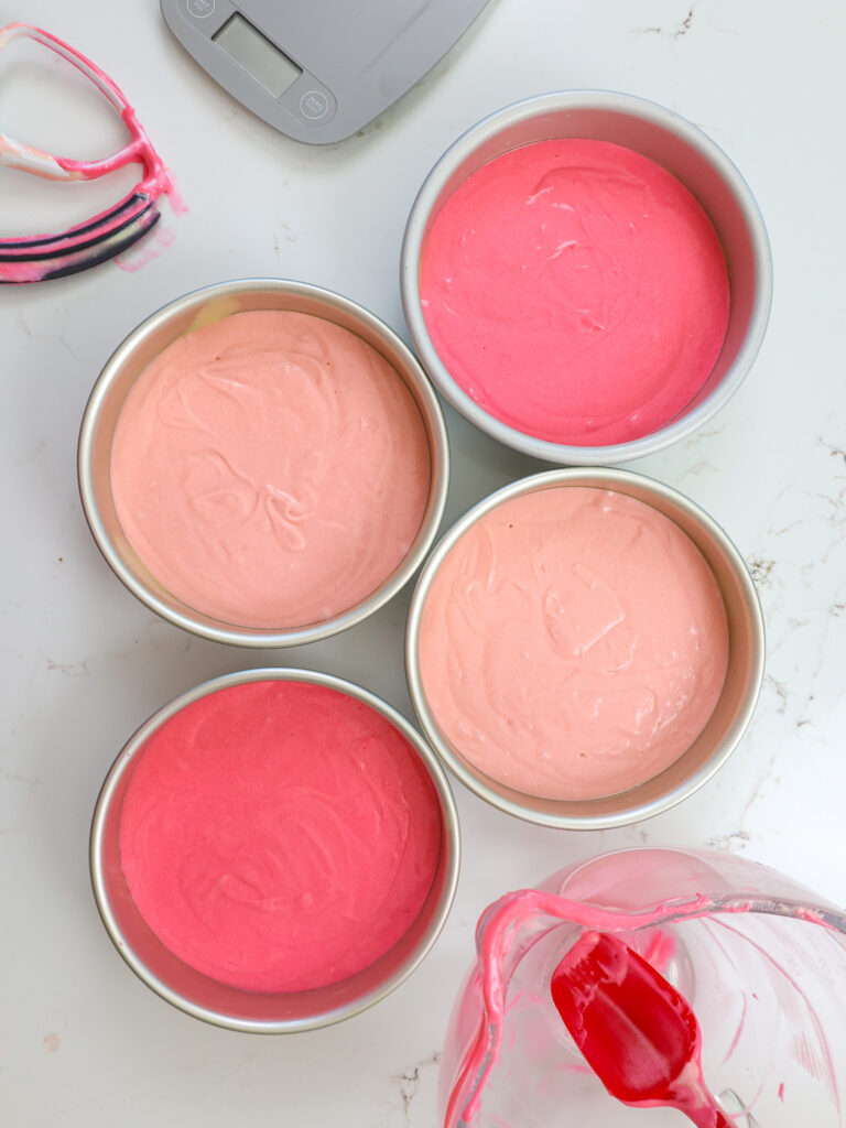 image of pink cake batter that's been poured into 7-inch cake pans 