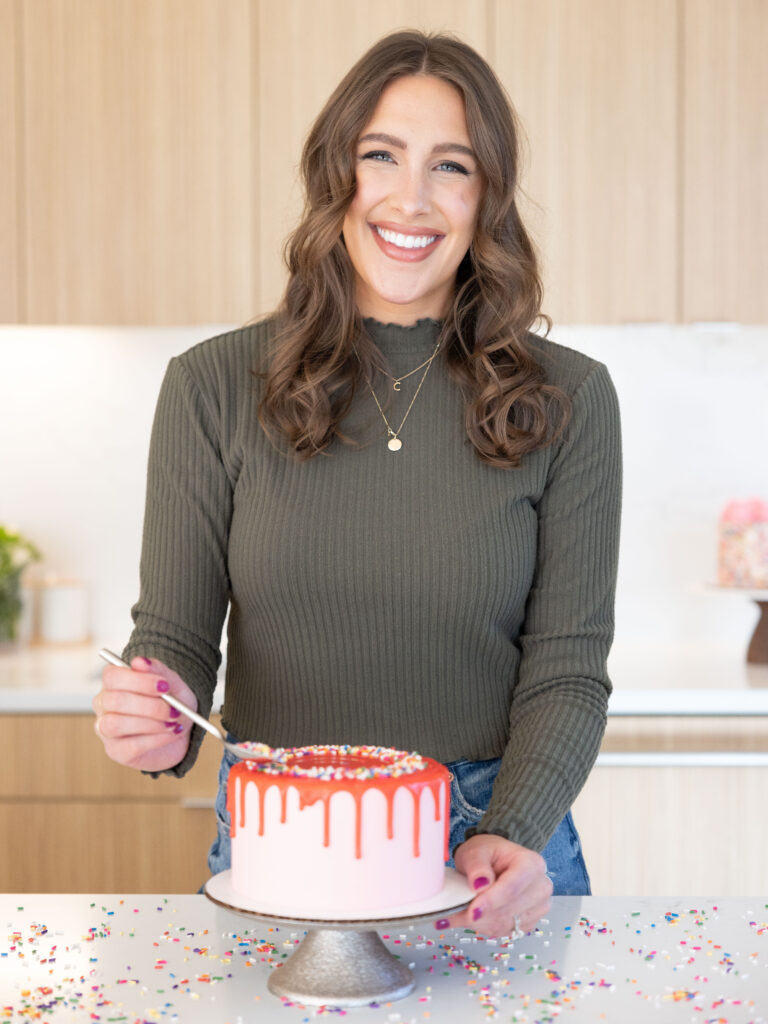 image of chelsey white of chelsweets making a pink drip cake in her seattle home