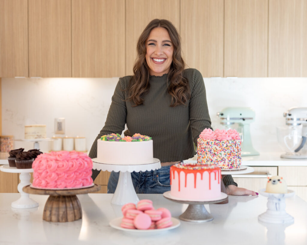 image of chelsey white of chelsweets with a bunch of cakes she made