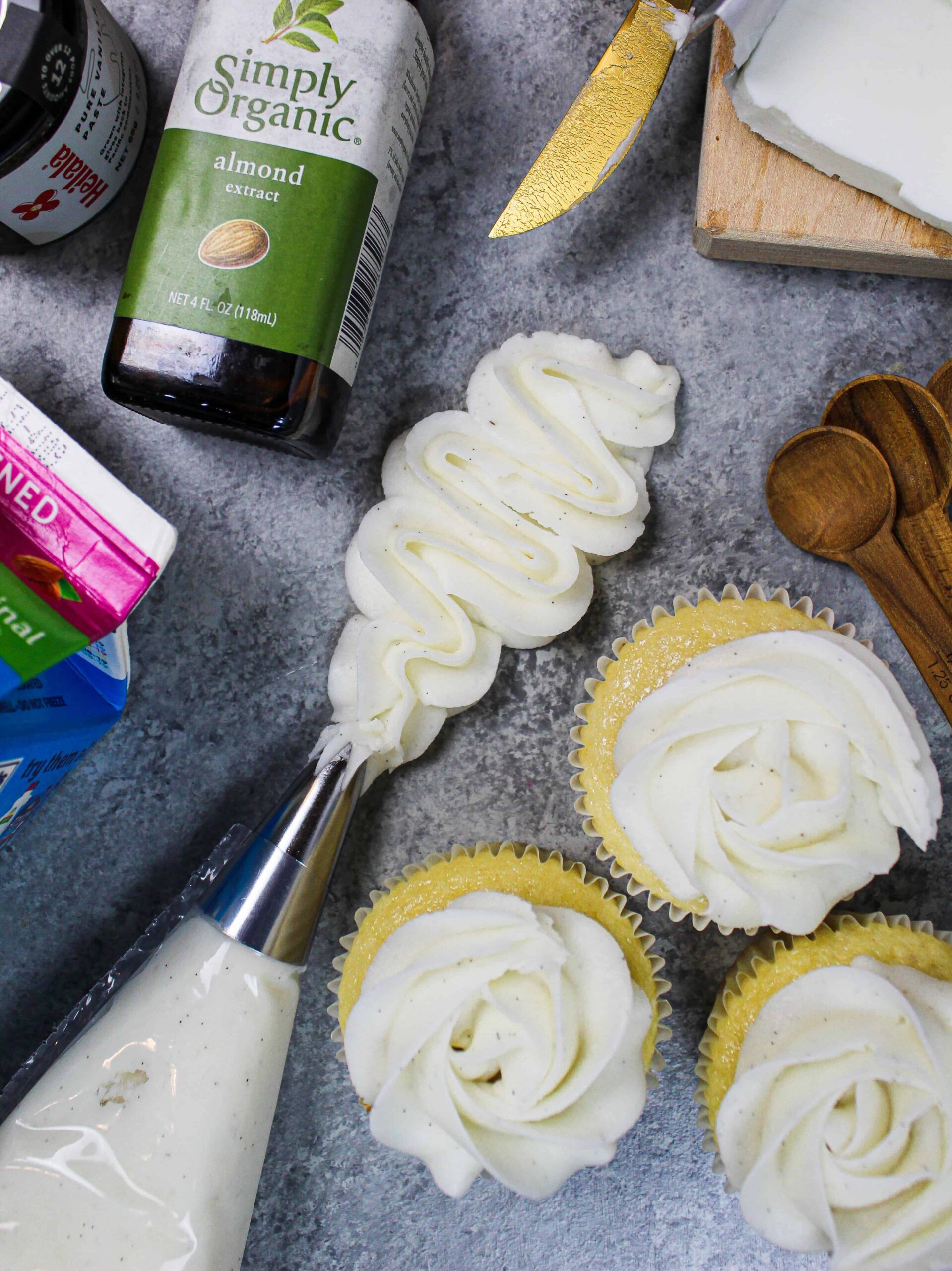 image of vegan frosting ingredients laid out around a squiggle of piped frosting to show how smooth it is