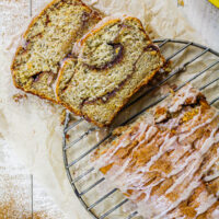 image of cinnamon swirl banana bread loaf that's been sliced into to show its beautiful cinnamon sugar swirls