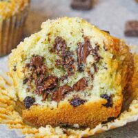 image of chocolate chip muffin that's been bitten into to show how fluffy and tender it is