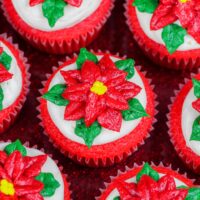 image of poinsettia cupcakes placed on a festive red cake stand