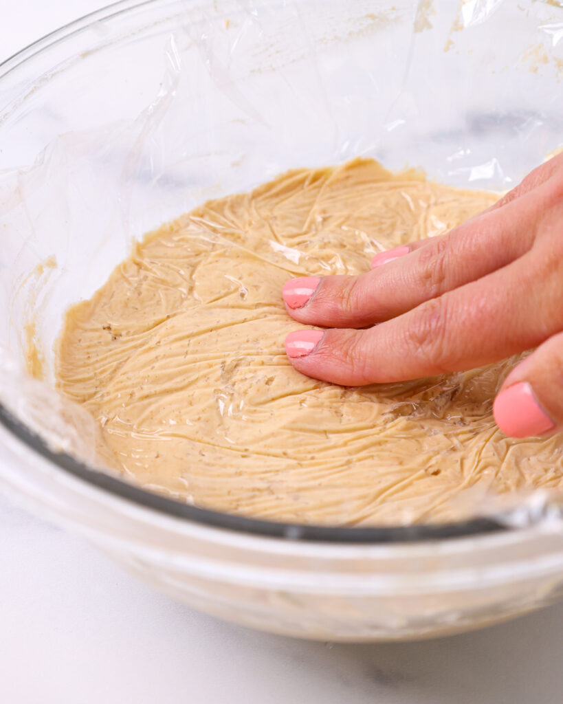 image of hazelnut mousse that's been covered with plastic wrap and is ready to be chilled in the fridge to set