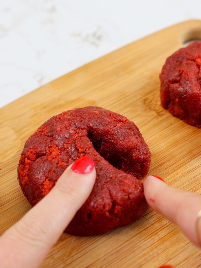 image of red velvet cake pop batter being used to shape crab claws for a crab cake