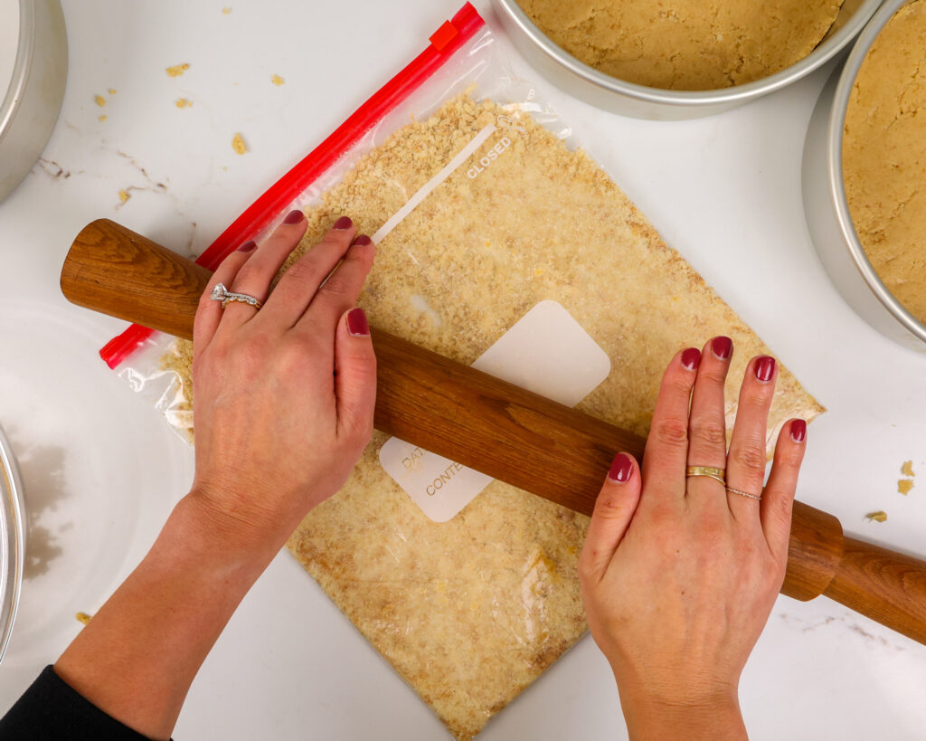 image of shortbread cookies being crushed to make a shortbread crust for a kinder bueno cake