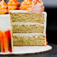image of a gluten free layered spice cake that's frosted with a cinnamon cream cheese frosting