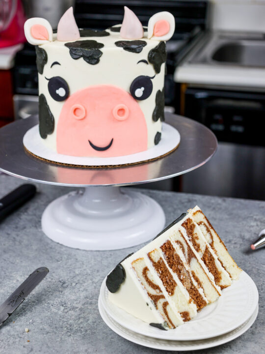 image of an adorable cow birthday cake made with marbled chocolate and vanilla cake layers