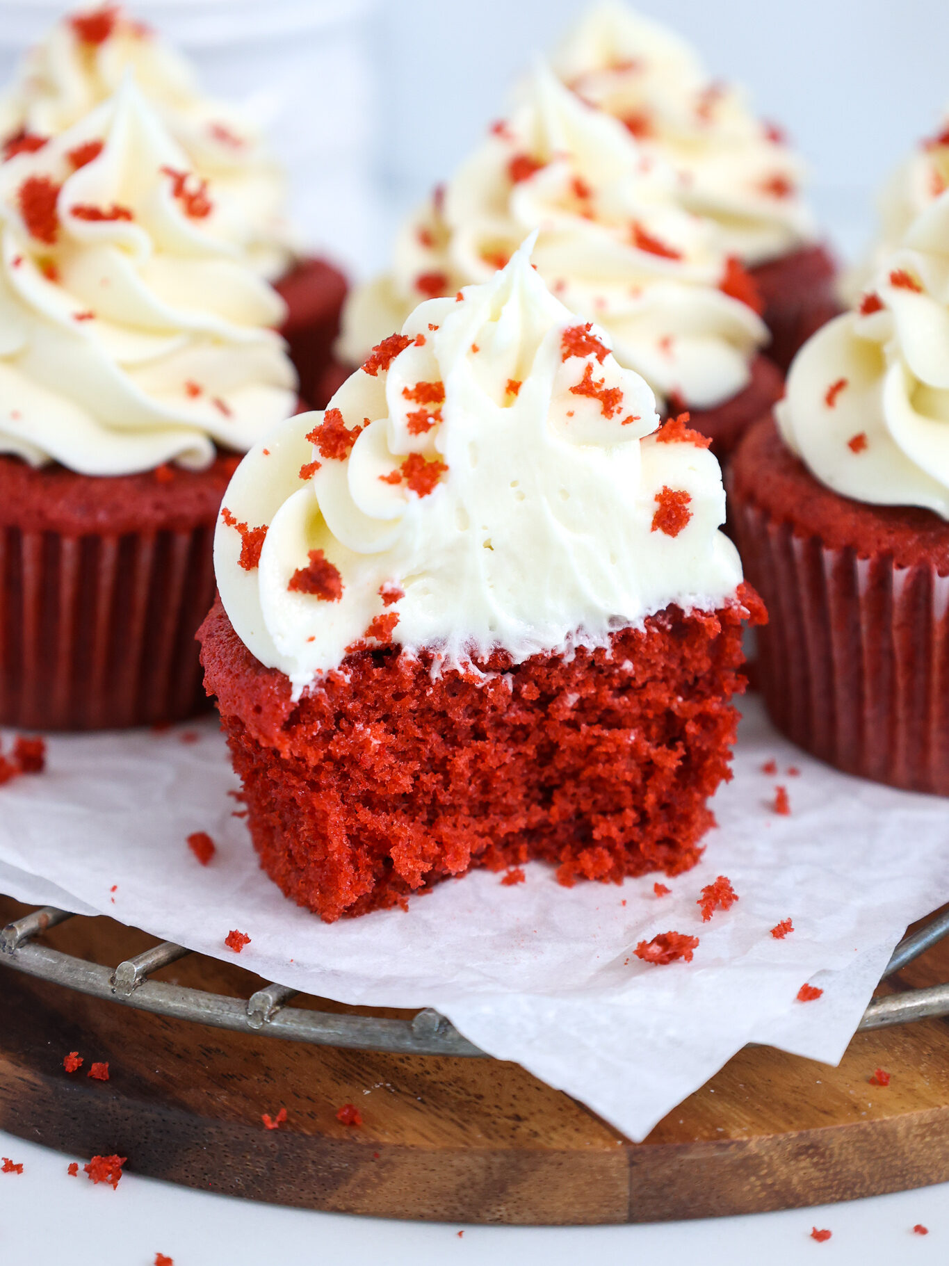 image of a red velvet cupcake that's been cut into to show how tender and soft it is