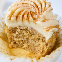 image of a spice cake that's been bitten into to show how moist and tender the cupcake is