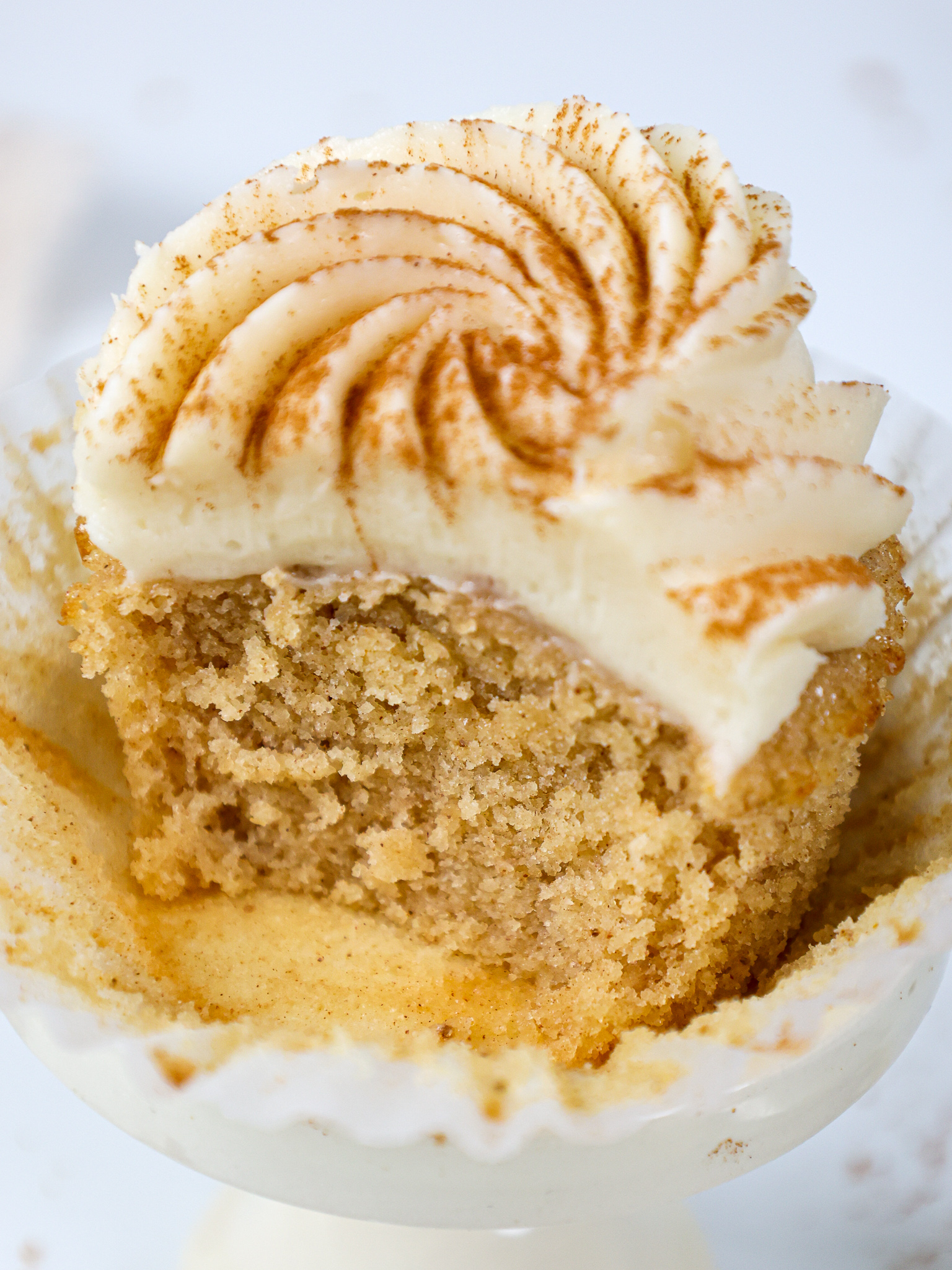 image of a spice cake that's been bitten into to show how moist and tender the cupcake is