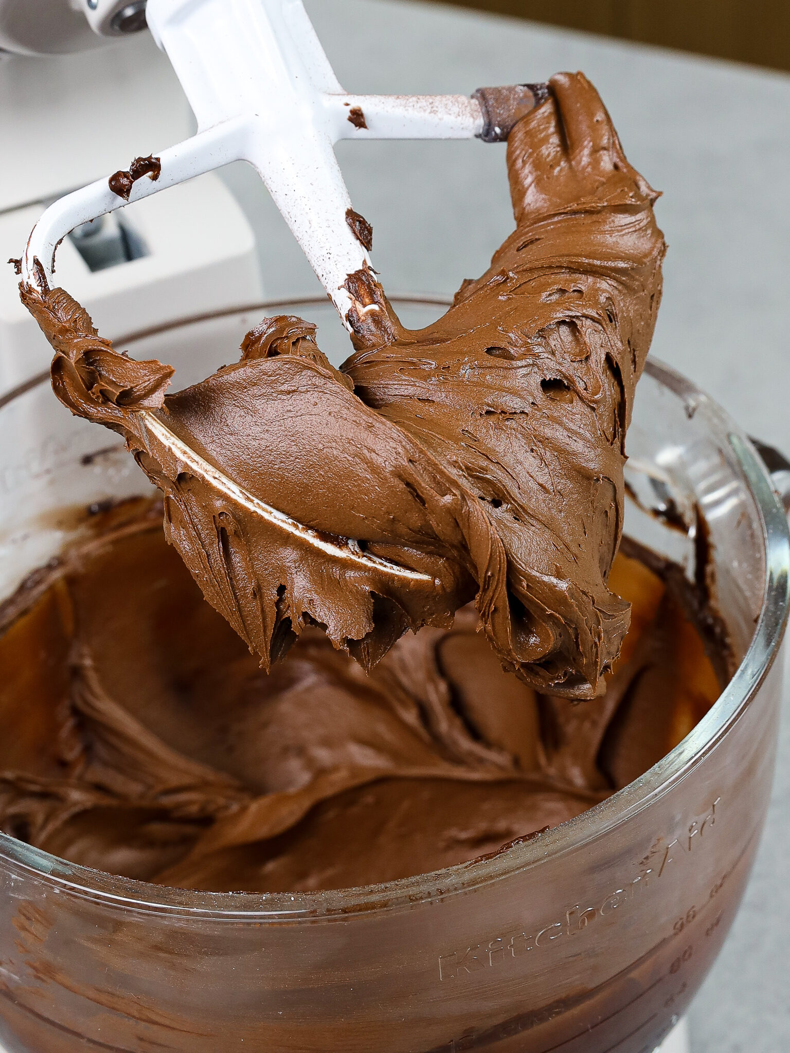 image of a small batch of dark chocolate buttercream that's been mixed and is ready to be used to frost a cake