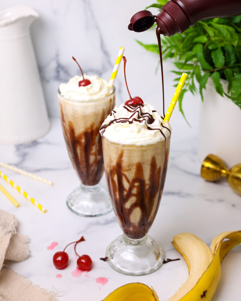 image of chocolate syrup being drizzled on top of a dirty monkey cocktail