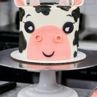 image of an adorable buttercream cow birthday cake made with marbled chocolate and vanilla cake layers