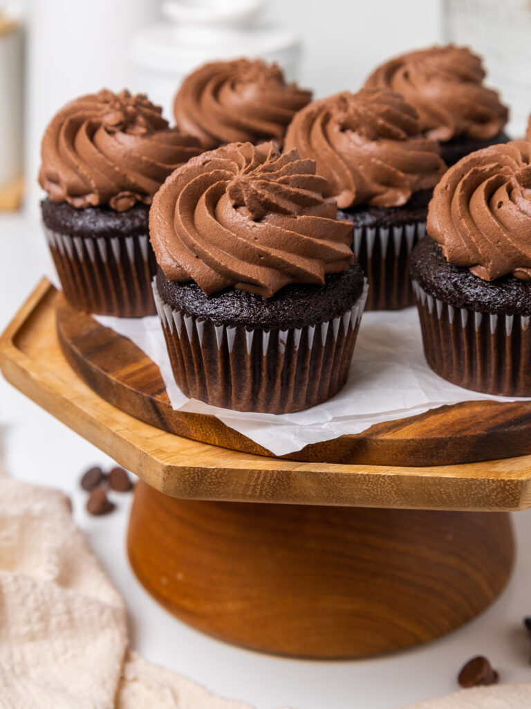 image of chocolate whipped cream frosting that's been piped on chocolate cupcakes using a large open star tip