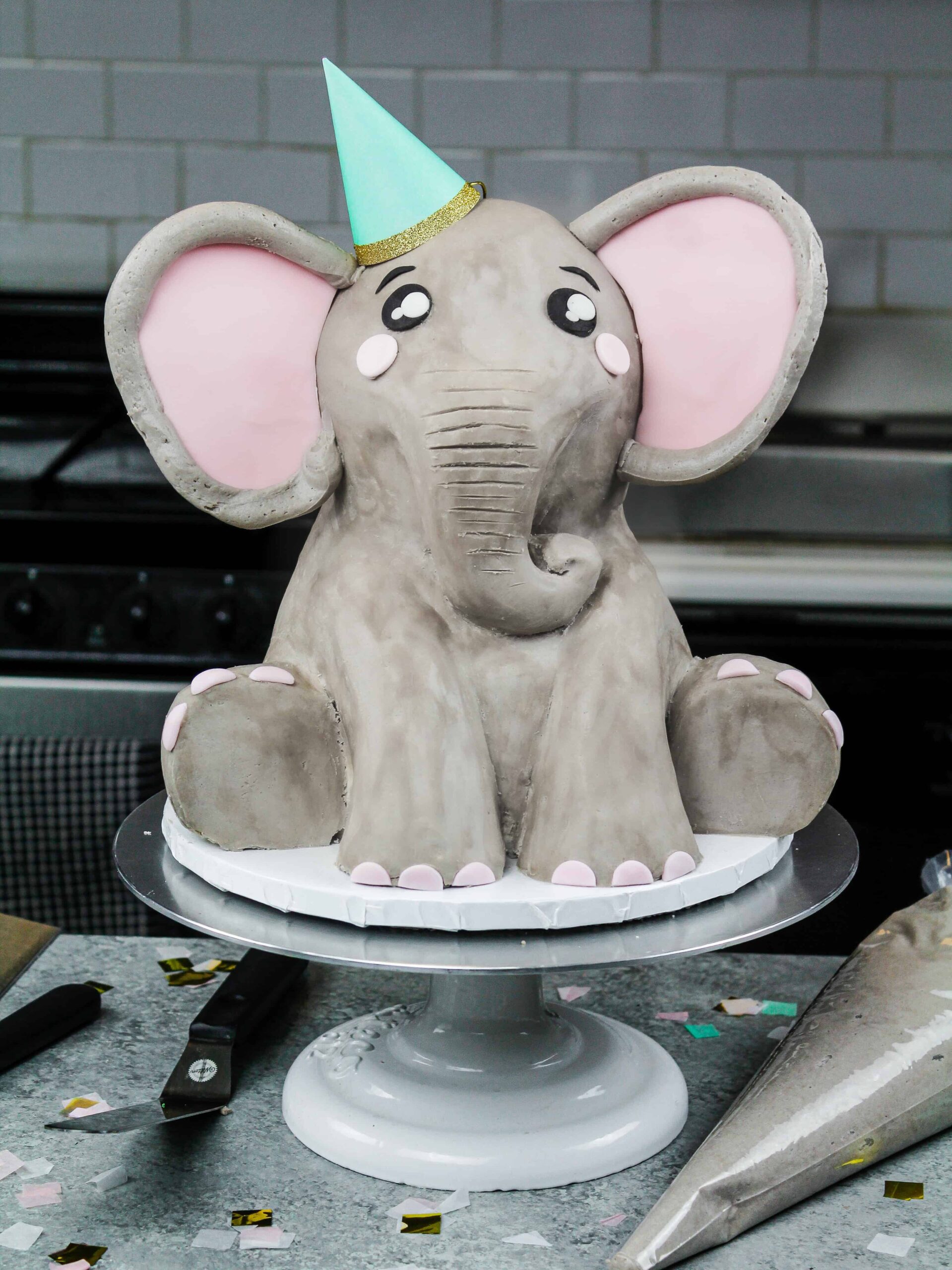 image of an elephant cake made mostly with buttercream and a little pink fondant