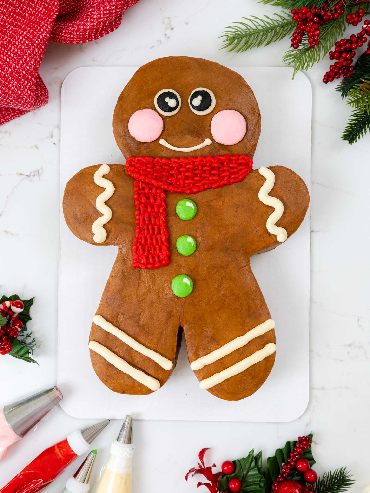 image of a gingerbread man cake that's been frosted with gingerbread buttercream frosting