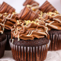 image of a kinder bueno cupcake that's been filled with hazelnut mousse and frosted with hazelnut chocolate buttercream frosting