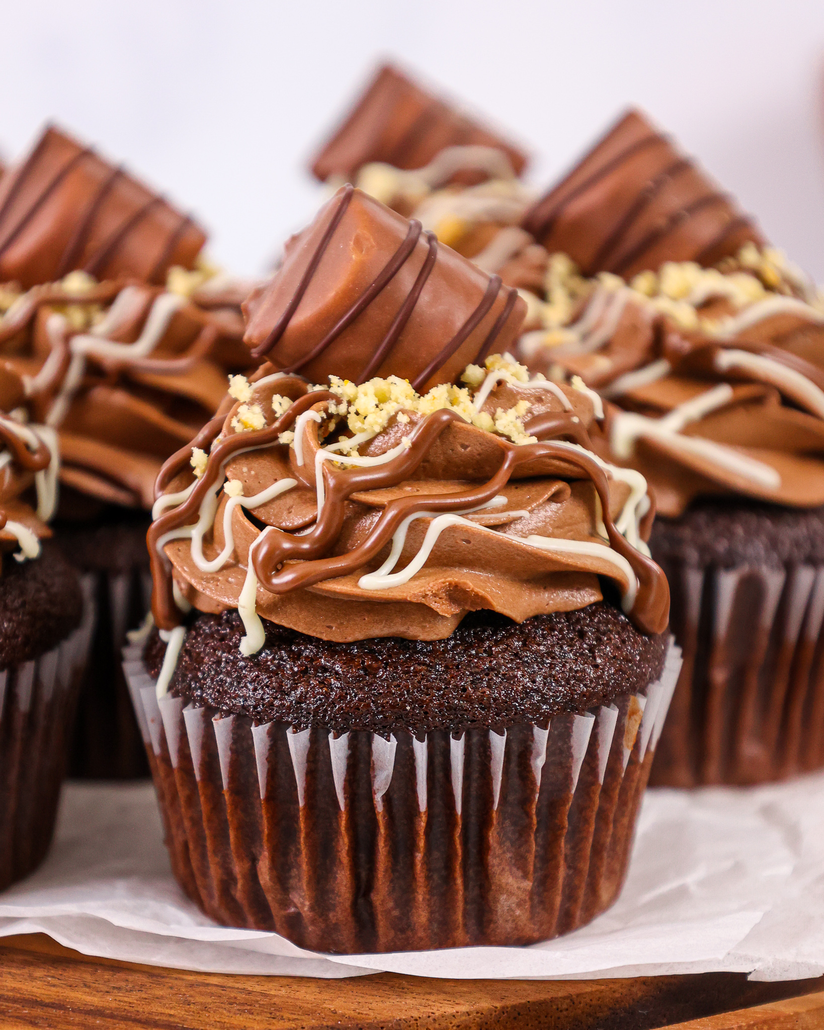 image of a kinder bueno cupcake that's been filled with hazelnut mousse and frosted with hazelnut chocolate buttercream frosting