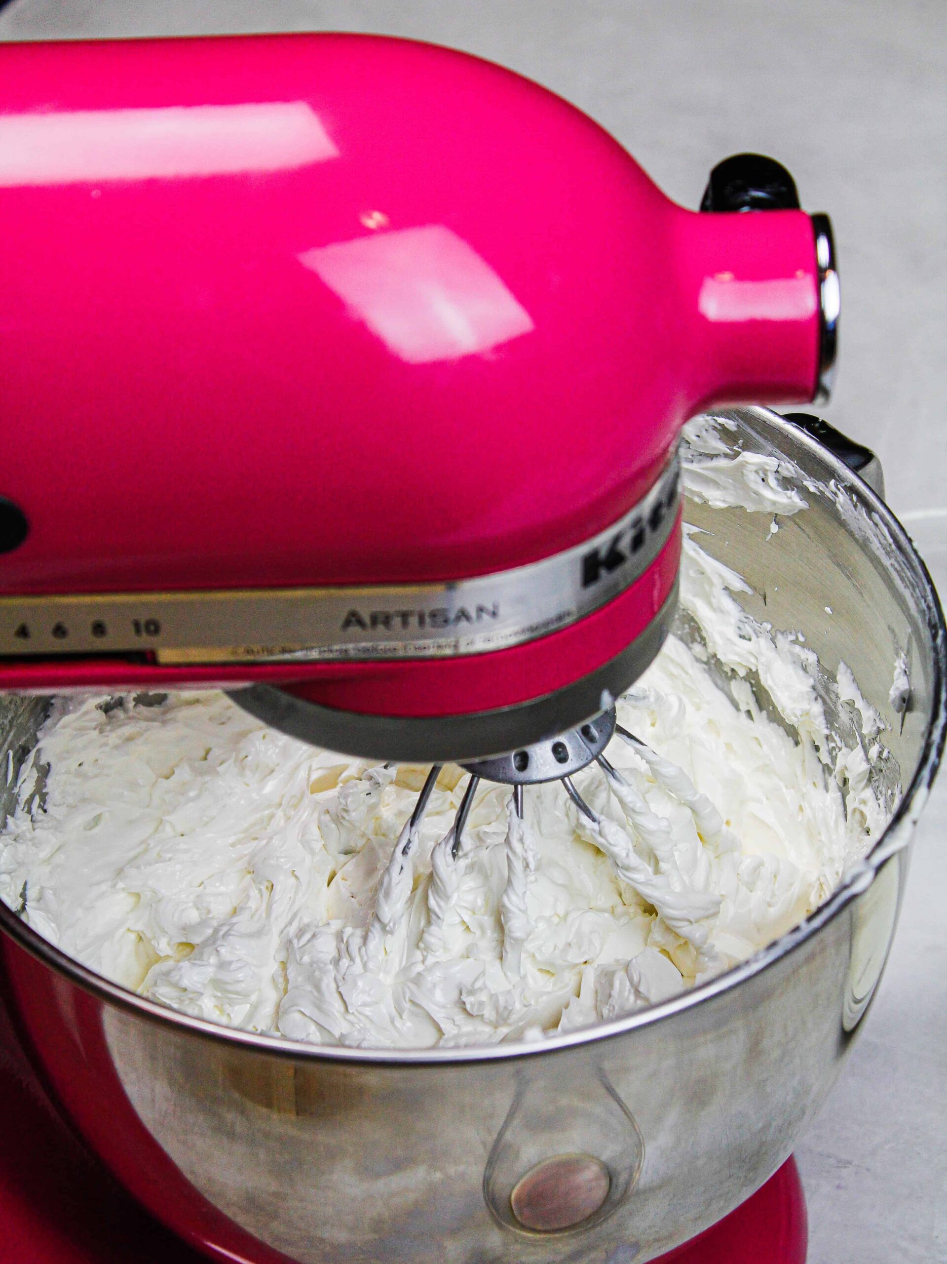 image of siwss meringue buttercream being made in a kitchen aid stand mixer