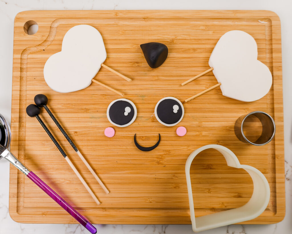 image of fondant wings and facial features that have been made to decorate a bumblebee cake