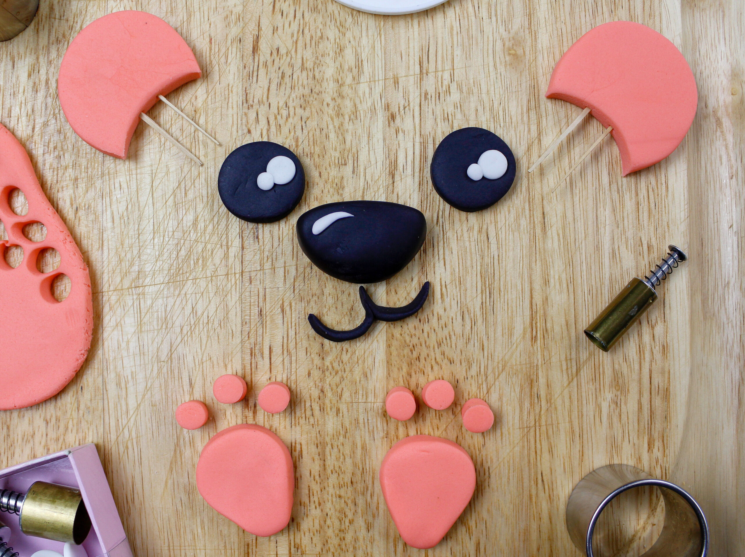 image of a fondant face and ears cut out to make a polar bear cake