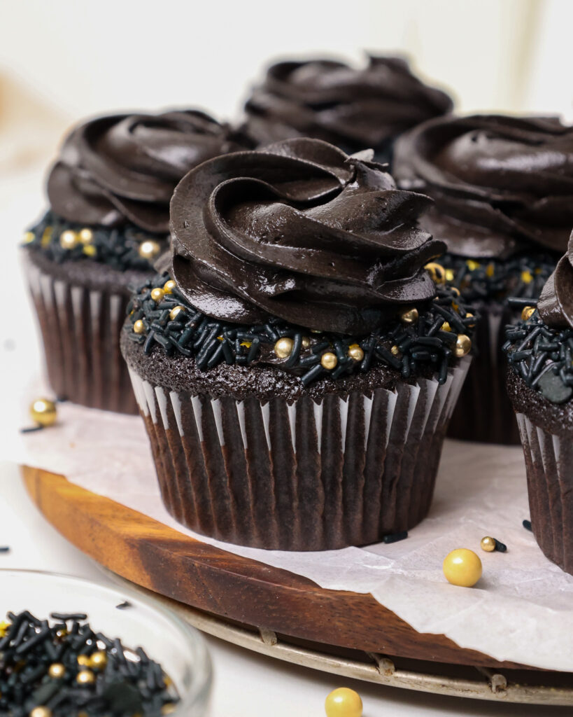 image of a black velvet cupcake that' been frosted with black cocoa buttercream