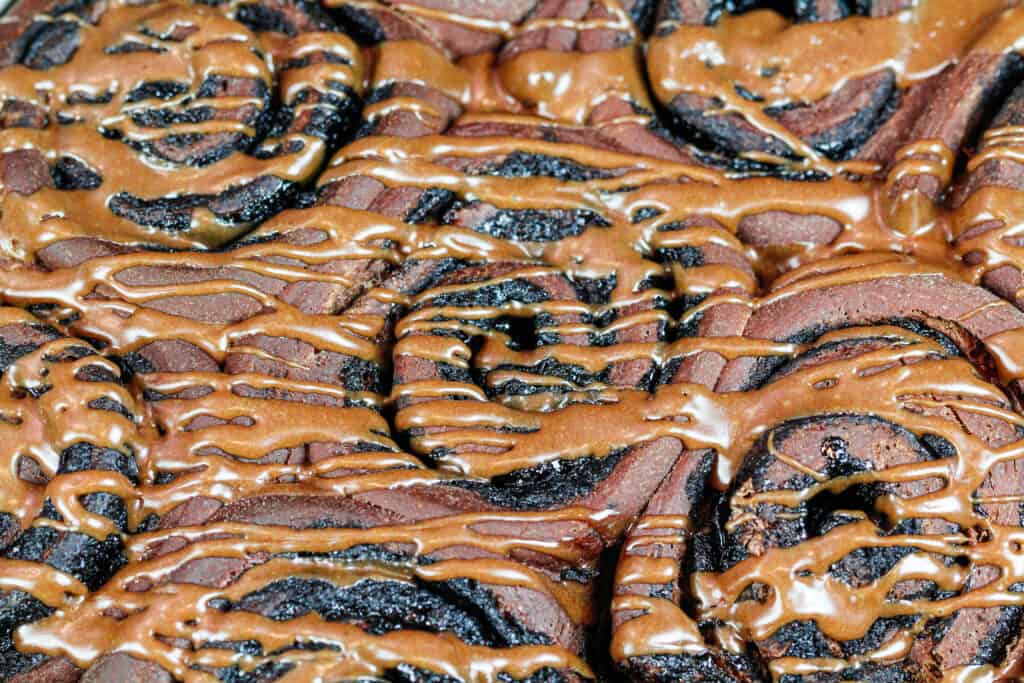 image of chocolate cinnamon rolls drizzled with a chocolate glaze
