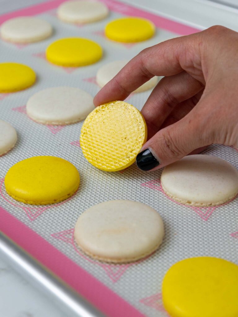 image of a french macaron shell that has been baked properly and has a shiny, smooth bottom