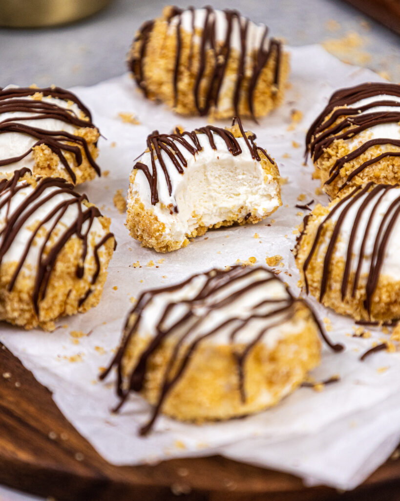 image of a creamy and delicious no bake cheesecake bite that's been bitten into to show it's incredible texture that's shared as part of a no bake recipe round up